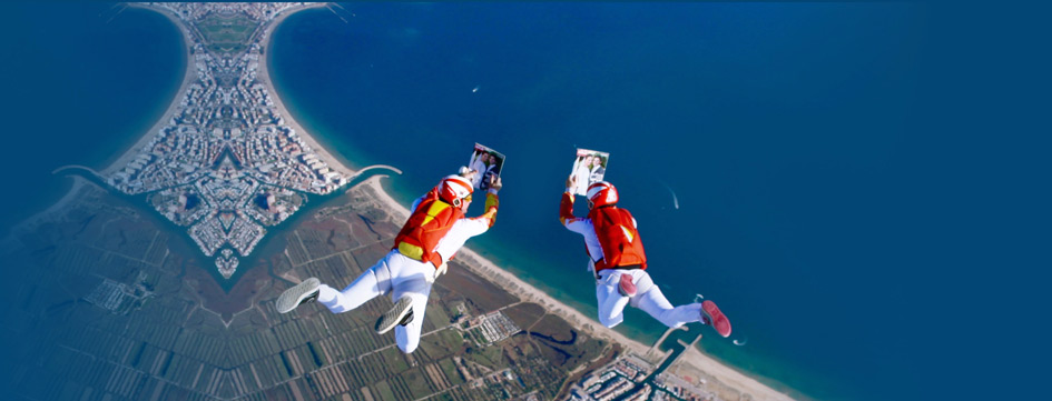 2 skydivers reading a magazine in freefall