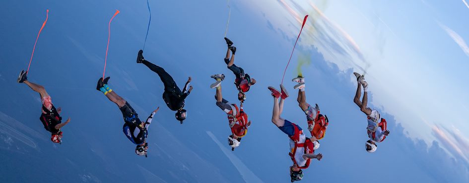 Aldo Comas skydiving in a black suit